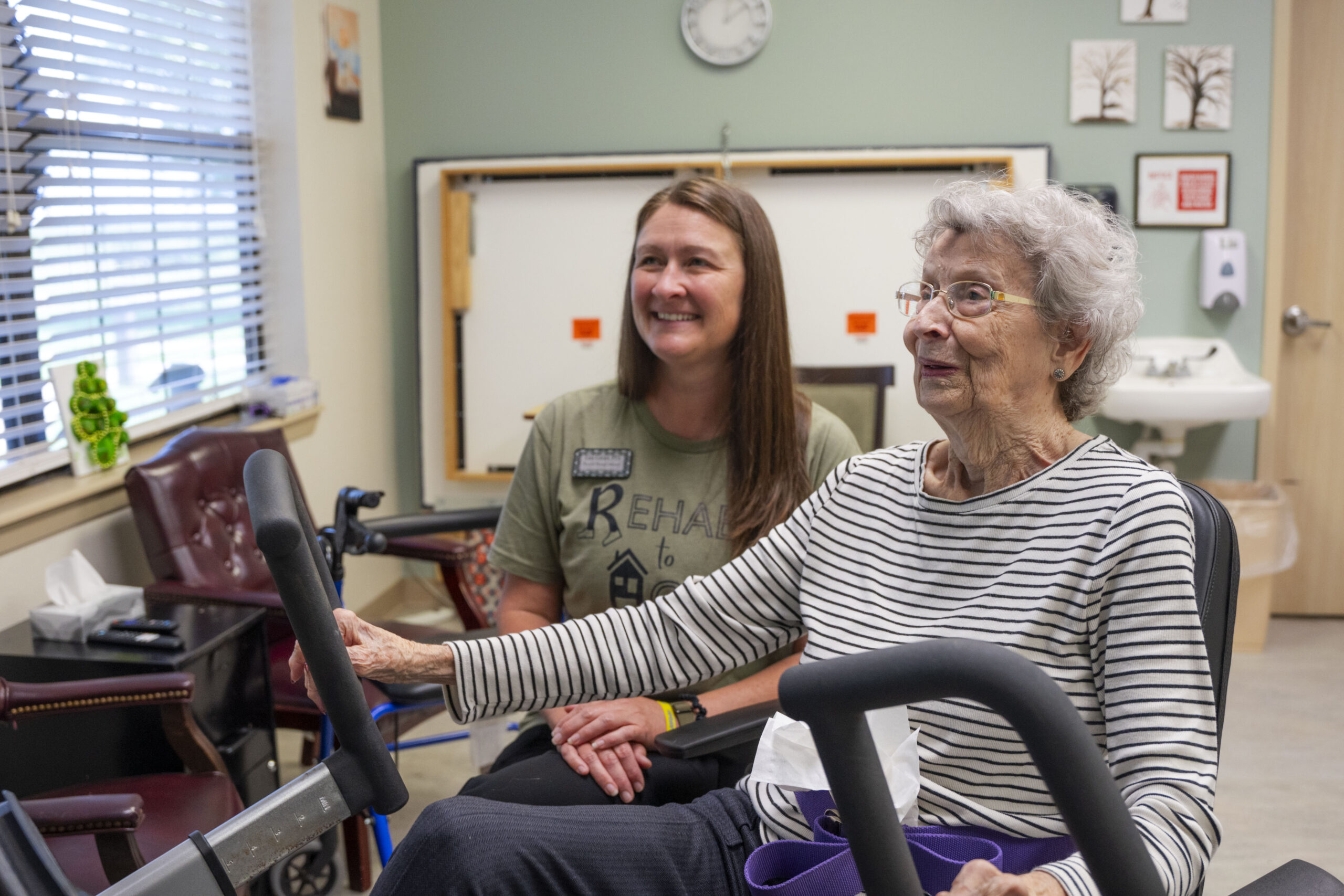Resident and therapist smiling at kent county nursing home
